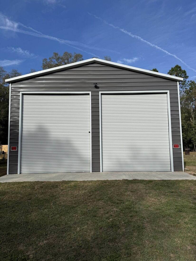 Finished two-bay metal garage building wired by Tinsley Electric