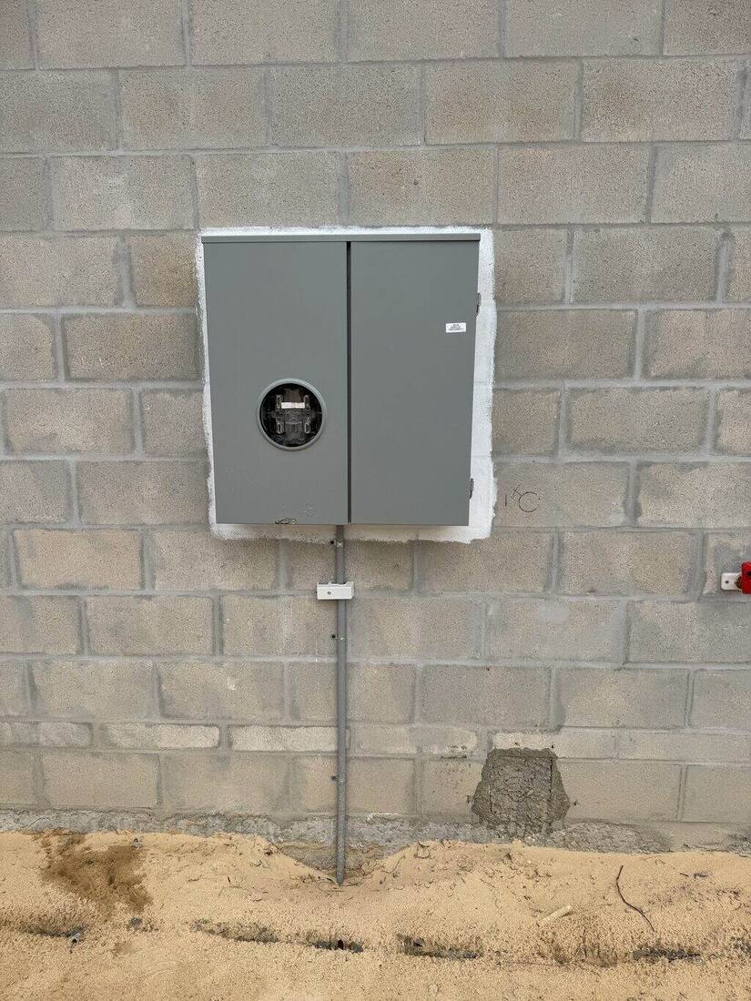 New electric meter and service panel installed on a block home