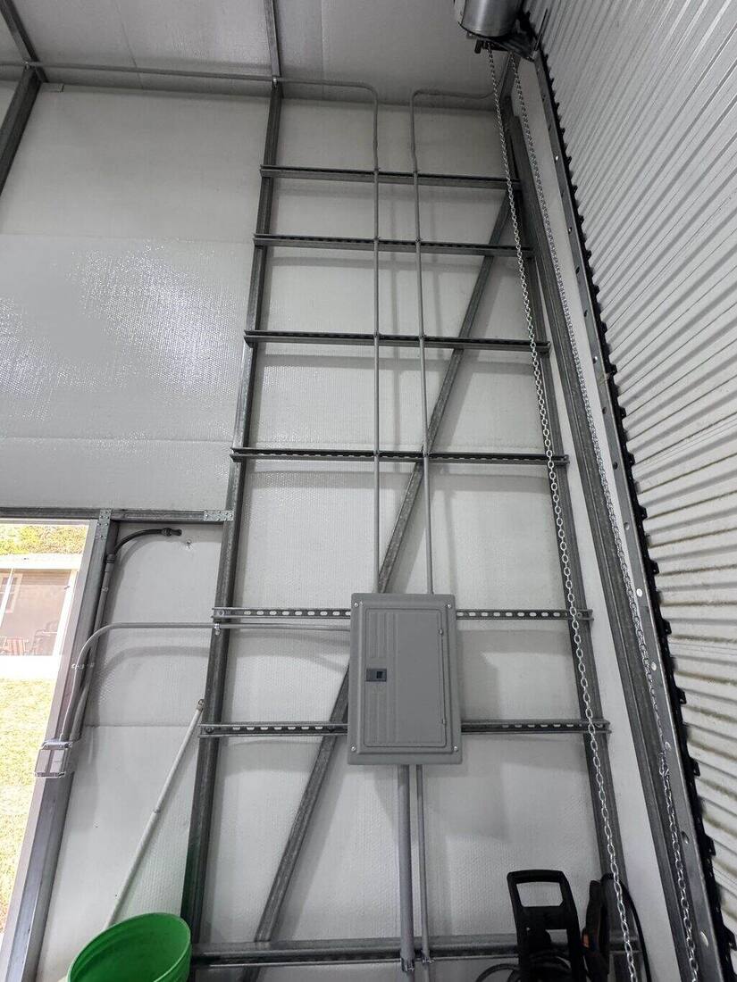Conduit and sub-panel installed inside a metal building